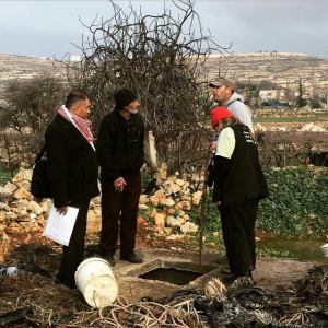 From left, Hisham Sharabati of Al Haq, Atta Jaber, Hasan Bader Jaber, CPT Palestine member at Hasan's cistern that has received demolition order from the Israeli military.
